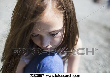 Stock Photo - A young girl in contemplation; Victoria, British Columbia, Canada. Fotosearch