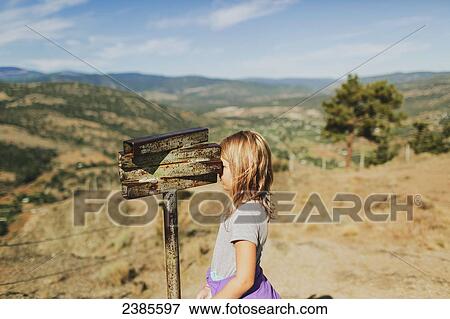 A young girl looks through an old rusty set of binoculars; Peachland, British Columbia, Canada View Large Photo Image Stock Photo - A young girl looks through an old rusty set of binoculars; Peachland, British Columbia, Canada. Fotosearch