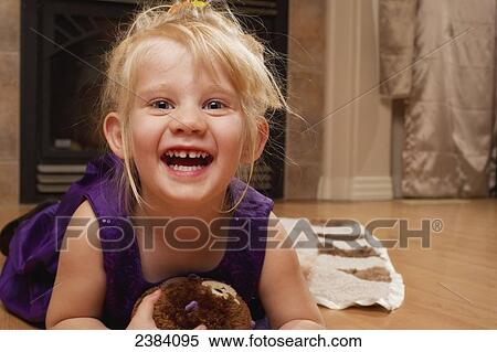 Stock Photography - A young girl wearing a purple formal dresses poses for the camera; Alberta, Canada. Fotosearch