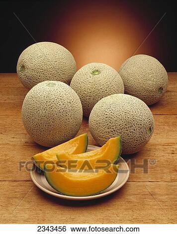 Agriculture - Fruit, Cantaloupes with sliced cantaloupe on plate. View Large Photo Image Stock Photograph - Agriculture - Fruit, Cantaloupes with sliced cantaloupe on plate.. Fotosearch