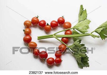 Stock Photo - Alaska grown tomatoes and celery leaves formed into a heart shape; Palmer, Alaska, United States of America. Fotosearch