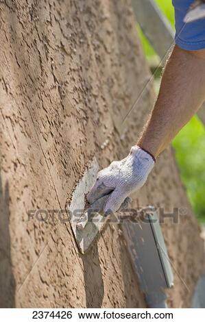 Stock Photograph - Applying stucco to a building; St. Albert, Alberta, Canada. Fotosearch