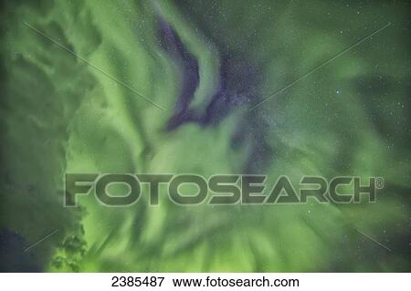 Stock Photo - Aurora borealis, or northern lights, directly overhead; Manitoba, Canada. Fotosearch
