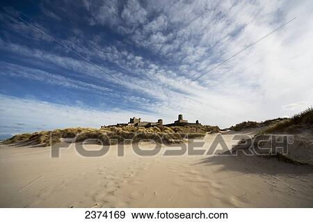Stock Photo - Bamburgh Castle viewed from the beach; Bamburgh, Northumberland, England. Fotosearch