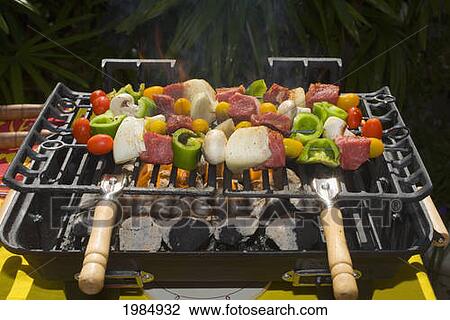Stock Image - Barbecue Scene, Shish Kabob On The Grill.. Fotosearch
