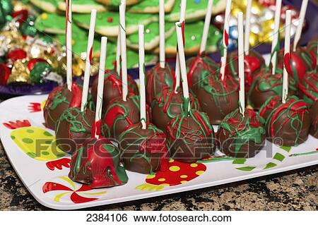 Cake pops decorated with red and green icing and a platter of baking for Christmas; Alberta, Canada View Large Photo Image Stock Photograph - Cake pops decorated with red and green icing and a platter of baking for Christmas; Alberta, Canada. Fotosearch