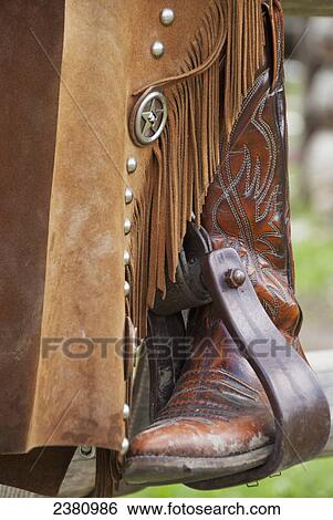 Close-up of a cowboy boot in the stirrups; Alberta, Canada View Large Photo Image Stock Photograph - Close-up of a cowboy boot in the stirrups; Alberta, Canada. Fotosearch