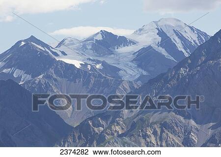 Close up of glacier mountains with blue sky and clouds; Yukon, Canada View Large Photo Image Stock Image - Close up of glacier mountains with blue sky and clouds; Yukon, Canada. Fotosearch