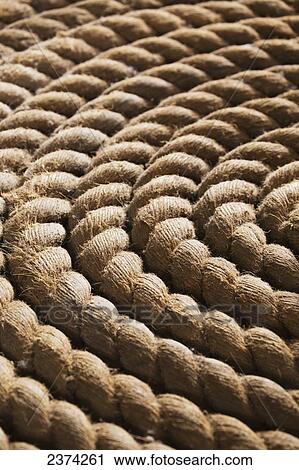 Stock Image - Close up of thick rope wrapped in a circle; Whitehorse, Yukon, Canada. Fotosearch