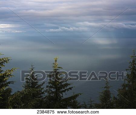 Stock Photography - Clouds cast shadows on the vast pacific ocean; Manzanita, Oregon, United States of America. Fotosearch