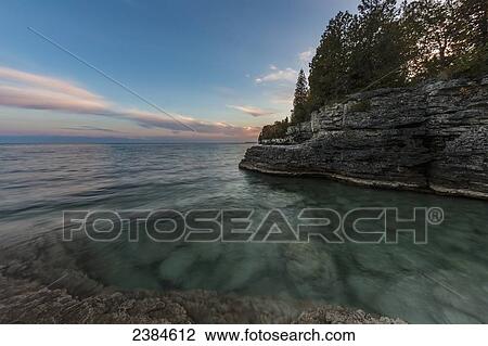 Stock Image - Clouds stretched out by a long exposure in Cave Point, Sturgeon Bay; Wisconsin, United States of America. Fotosearch