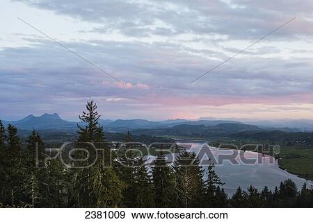 Stock Photo - Clouds turn pink in the evening over Youngs Bay; Astoria, Oregon, United States of America. Fotosearch