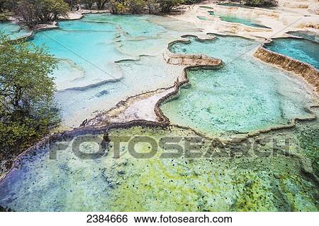 Stock Photograph - Colourful pools formed by calcite deposits; Huanglong, Sichuan province, China. Fotosearch