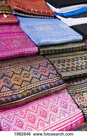 Stock Photograph - Colourful silk fabrics displayed for sale; Mae Sariang, Thailand. Fotosearch