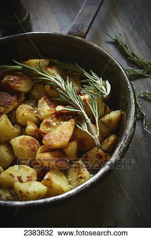 Crunchy potatoes with rosemary in an old iron pan View Large Photo Image Stock Image - Crunchy potatoes with rosemary in an old iron pan. Fotosearch