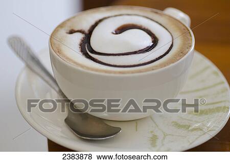 Cup of coffee with a chocolate swirl; Maesalong, Chiang Rai, Thailand View Large Photo Image Stock Photo - Cup of coffee with a chocolate swirl; Maesalong, Chiang Rai, Thailand. Fotosearch