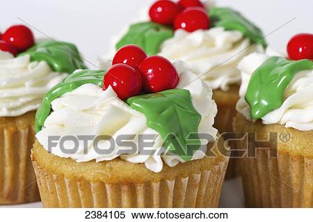 Cupcakes decorated with holly and berries for Christmas; Alberta, Canada View Large Photo Image Stock Photography - Cupcakes decorated with holly and berries for Christmas; Alberta, Canada. Fotosearch