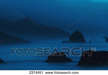 Stock Image - Dawn reveals the coastline; Cannon Beach, Oregon, United States of America. Fotosearch