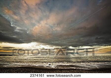 Dramatic clouds at sunset over the water; South Shields, Tyne and Wear, England View Large Photo Image Stock Image - Dramatic clouds at sunset over the water; South Shields, Tyne and Wear, England. Fotosearch
