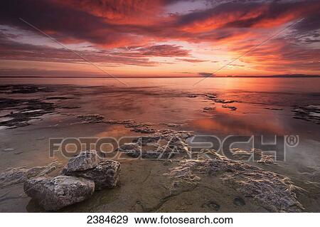 Dramatic sunrise at Cave Point with brilliant colours; Wisconsin, United States of America View Large Photo Image Stock Photo - Dramatic sunrise at Cave Point with brilliant colours; Wisconsin, United States of America. Fotosearch