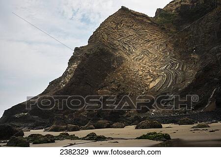 Stock Photo - Erosion reveals rock strata; Cannon Beach, Oregon, United States of America. Fotosearch