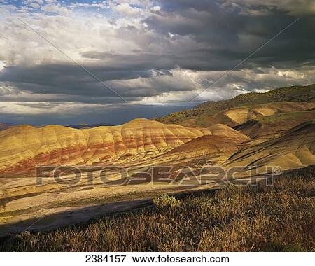 Evening light brightens the ridges of the Painted Hills Unit; Mitchell, Oregon, United States of America View Large Photo Image Stock Photo - Evening light brightens the ridges of the Painted Hills Unit; Mitchell, Oregon, United States of America. Fotosearch