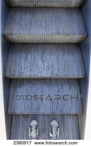 Stock Photo - Feet on an escalator; Locarno, Ticino, Switzerland. Fotosearch