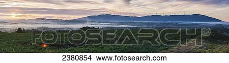 Fog rolling across the landscape with wind turbines in a row on the top of a hill; Presque Isle, Maine, United States of America View Large Photo Image Picture - Fog rolling across the landscape with wind turbines in a row on the top of a hill; Presque Isle, Maine, United States of America. Fotosearch