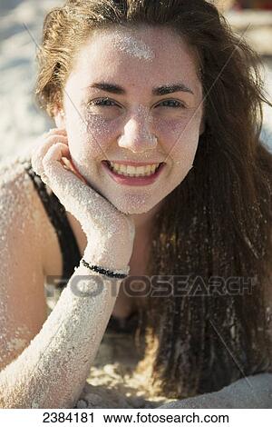 Stock Image - Girl at the beach covered in sand; Koh Samet Island, Thailand. Fotosearch