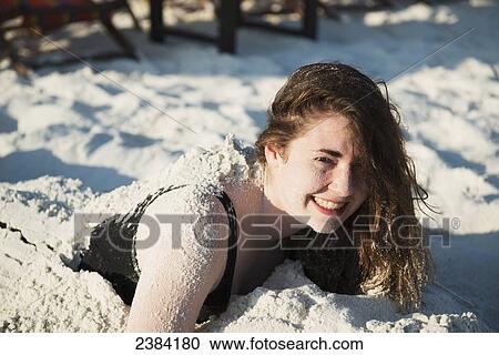Girl buried in the sand; Koh Samet Island, Thailand View Large Photo Image Stock Image - Girl buried in the sand; Koh Samet Island, Thailand. Fotosearch