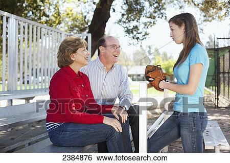Girl with baseball glove talking to her parents; Menlo Park, California, United States of America View Large Photo Image Stock Photograph - Girl with baseball glove talking to her parents; Menlo Park, California, United States of America. Fotosearch