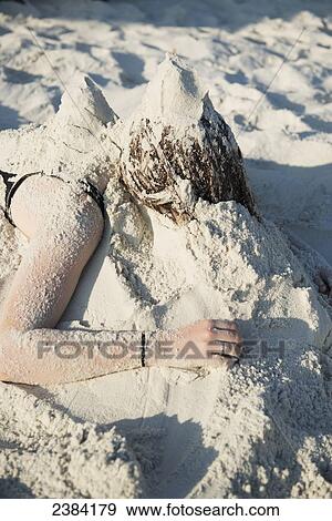 Girl with her head in the sand; Koh Samet Island, Thailand View Large Photo Image Stock Photo - Girl with her head in the sand; Koh Samet Island, Thailand. Fotosearch