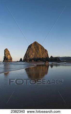Stock Image - Haystack Rock, a famous landmark; Cannon Beach, Oregon, United States of America. Fotosearch