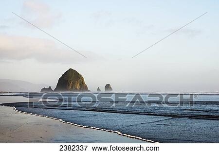 Stock Photo - Haystack Rock at Cannon Beach, a famous landmark; Cannon Beach, Oregon, United States of America. Fotosearch