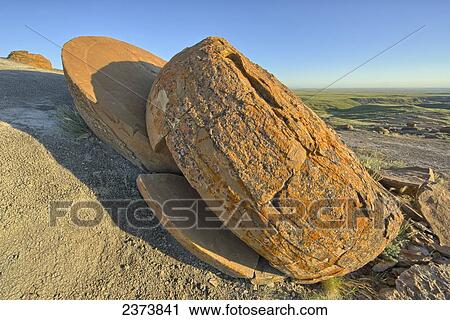 Stock Image - Large fractured red rock, Red Rock Coulee; Alberta, Canada. Fotosearch