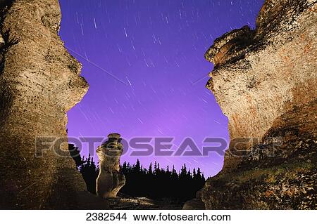 Picture - Light painting on monolith and star trails, Anse des Bonnes Femmes at Ile Niapiskau, Mingan Archipelago National Park Reserve of Canada, Cote-Nord, Duplessis region; Quebec, Canada. Fotosearch