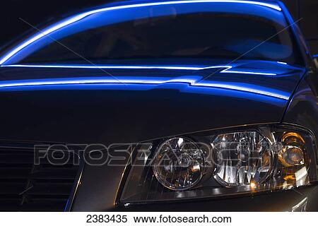 Stock Photography - Light reflects on the hood and windshield of a brand new car; Ascona, Ticino, Switzerland. Fotosearch
