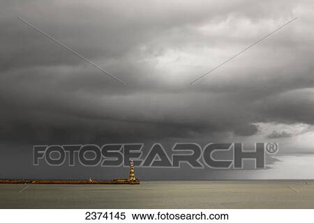 Lighthouse at the end of a pier with dark storm clouds overhead; Sunderland, Tyne and Wear, England View Large Photo Image Stock Photography - Lighthouse at the end of a pier with dark storm clouds overhead; Sunderland, Tyne and Wear, England. Fotosearch