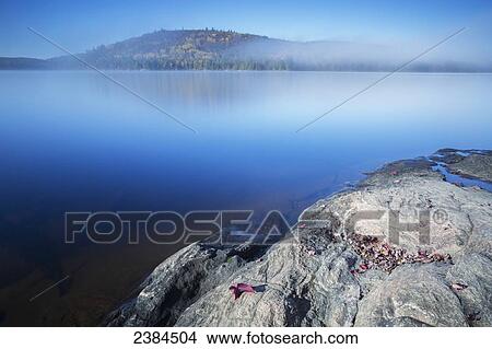 Long exposure of mist rising off of Grand Lake, Algonquin Park; Ontario, Canada View Large Photo Image Picture - Long exposure of mist rising off of Grand Lake, Algonquin Park; Ontario, Canada. Fotosearch