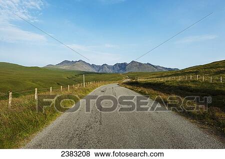 Stock Photo - Looking along the road between Carbost and Glen Brittle towards the Black Cuillin; Isle of Skye, Scotland. Fotosearch