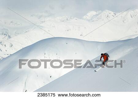 Stock Photography - Man skiing the west face of Peak 3720, Turnagain Arm, Chugach Mountains, Southcentral Alaska. Fotosearch