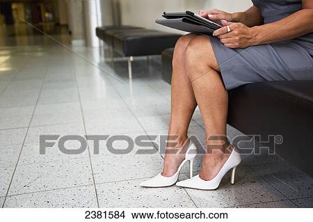 Picture - Mature Professional Businesswoman In Downtown Office Environment Using Tablet Device; Edmonton, Alberta, Canada. Fotosearch