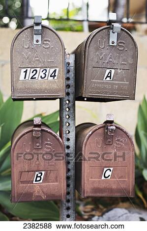 Stock Photo - Metal mailboxes on a post; Honolulu, Oahu, Hawaii, United States of America. Fotosearch