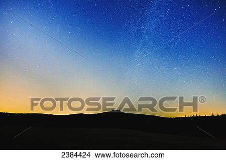 Picture - Milky way visible in the sky over Mount Pinnacle; Frelighsburg, Eastern Townships, Quebec, Canada. Fotosearch
