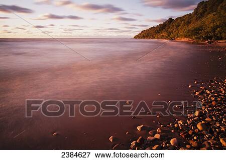 Stock Photo - Mist over the water of Lake Michigan at sunrise; Wisconsin, United States of America. Fotosearch