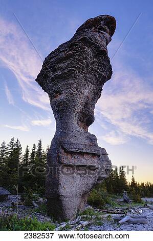 Stock Photo - Monolith at sunset, Anse des Bonnes Femmes at Ile Niapiskau, Mingan Archipelago National Park Reserve of Canada, Cote-Nord, Duplessis region; Quebec, Canada. Fotosearch