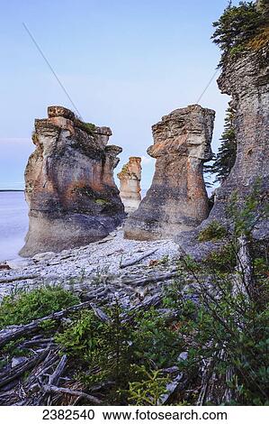 Stock Image - Monolith at twilight, Anse des Bonnes Femmes at Ile Niapiskau, Mingan Archipelago National Park Reserve of Canada, Cote-Nord, Duplessis region; Quebec, Canada. Fotosearch