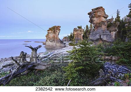 Stock Image - Monolith at twilight, Anse des Bonnes Femmes at Ile Niapiskau, Mingan Archipelago National Park Reserve of Canada, Cote-Nord, Duplessis region; Quebec, Canada. Fotosearch