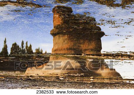 Stock Image - Monolith reflection at Anse des Bonnes Femmes at Ile Niapiskau, Mingan Archipelago National Park Reserve of Canada, Cote-Nord, Duplessis region; Quebec, Canada. Fotosearch