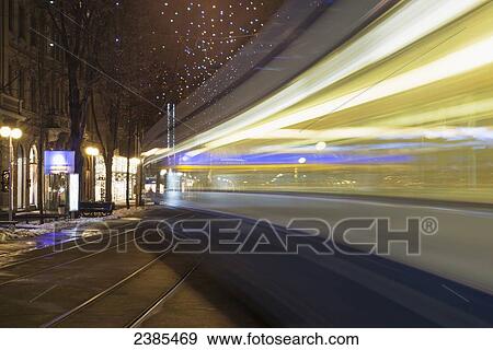 Motion blur of lights from a trolley car on the street; Zurich, Switzerland View Large Photo Image Stock Photo - Motion blur of lights from a trolley car on the street; Zurich, Switzerland. Fotosearch
